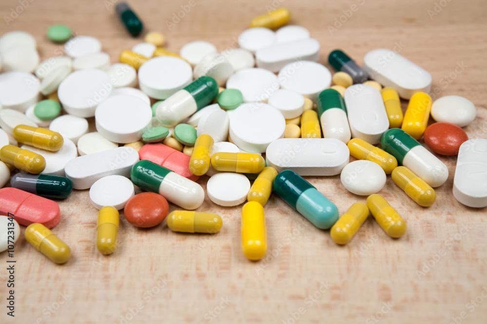 Composition with colorful pills and light grey background Composition with colorful pills and light grey background