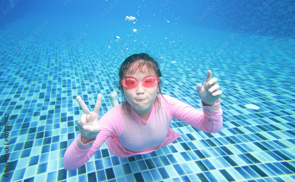 little asian girl underwater in swimming pool Stock Photo | Adobe Stock