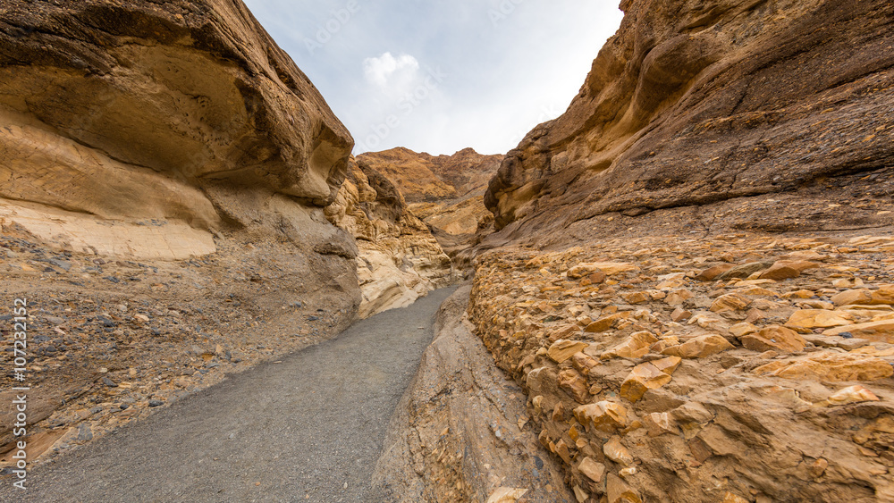 Hiking trail through the narrows at Mosaic Canyon. The canyon narrows dramatically to a deep slot cut. Mosaic Canyon, Death Valley National Park, California