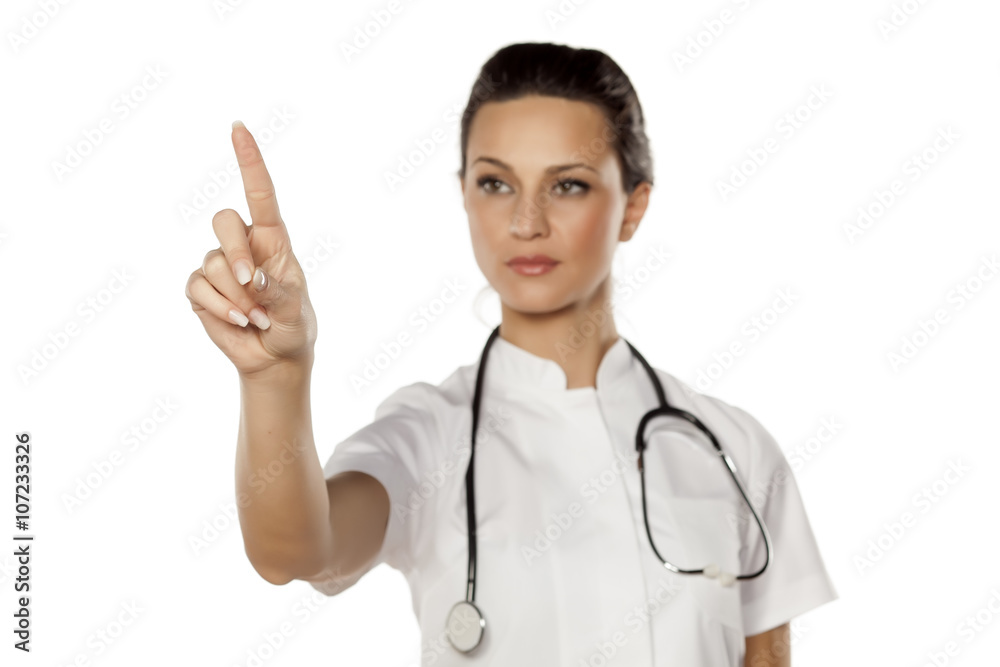 a young woman doctor touches empty screen a young woman doctor touches empty screen