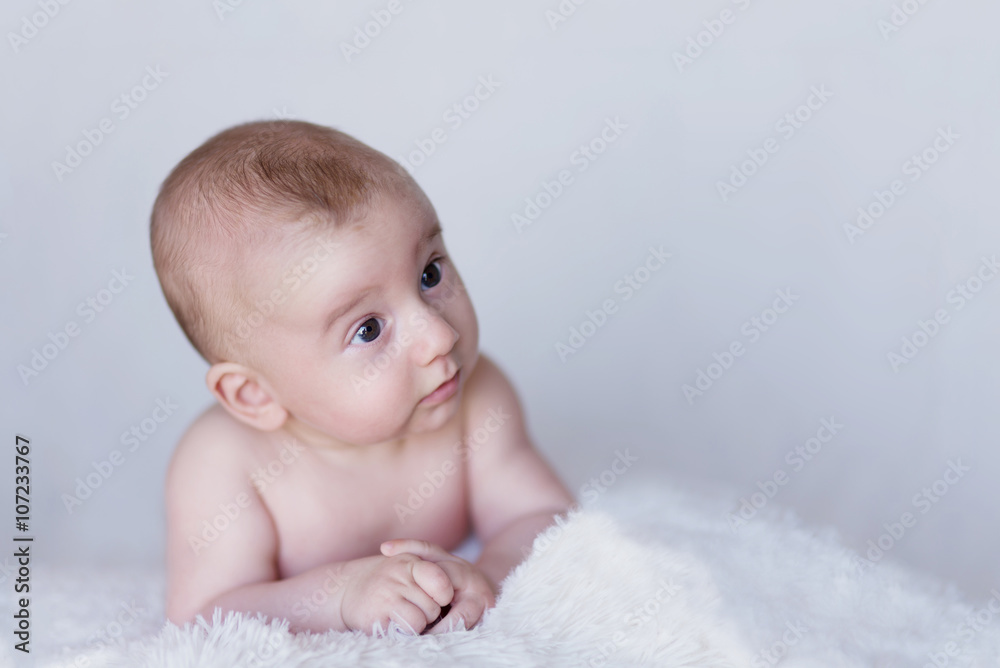 Newborn Naked Baby Curiously Observing Environment on a Soft Blanket Newborn Naked Baby Curiously Observing Environment on a Soft Blanket