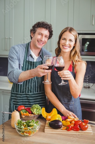 Portrait of happy couple toasting wine