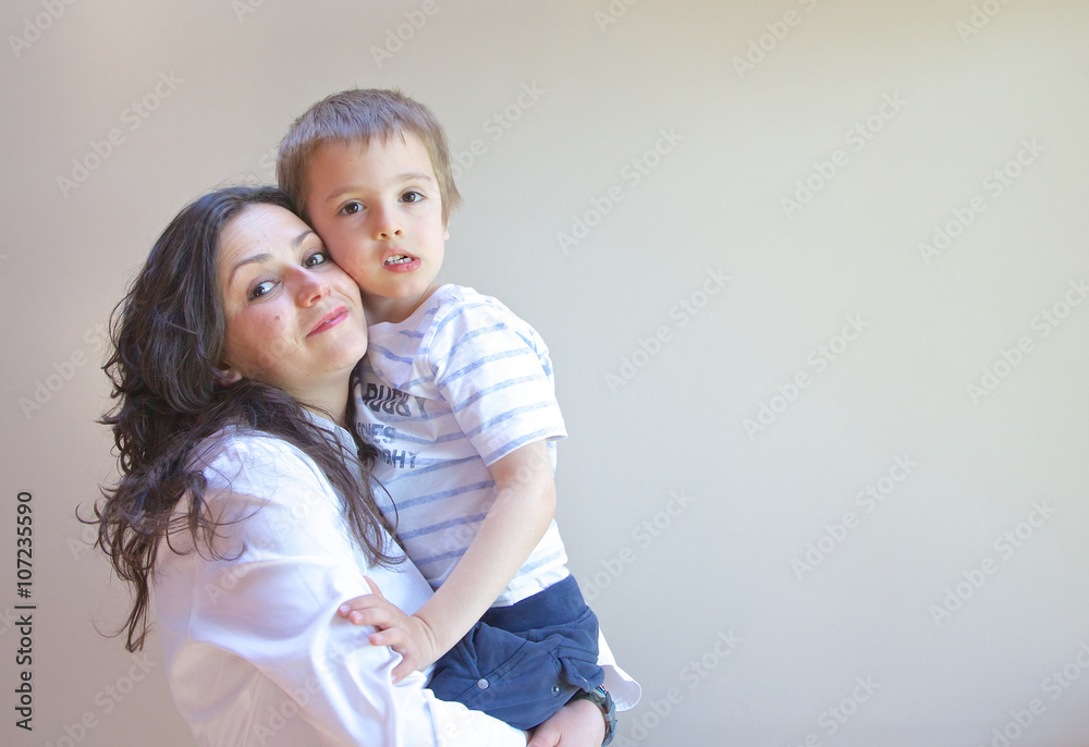 A young mother hugs her child A young mother hugs her child