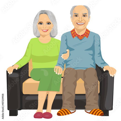 Romantic elderly couple sitting close together on a sofa