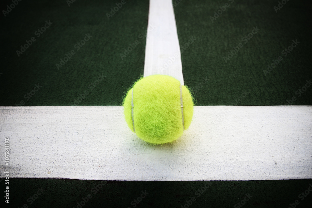 tennis ball on line tennis court