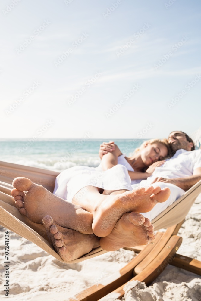 Couple sleeping in hammock