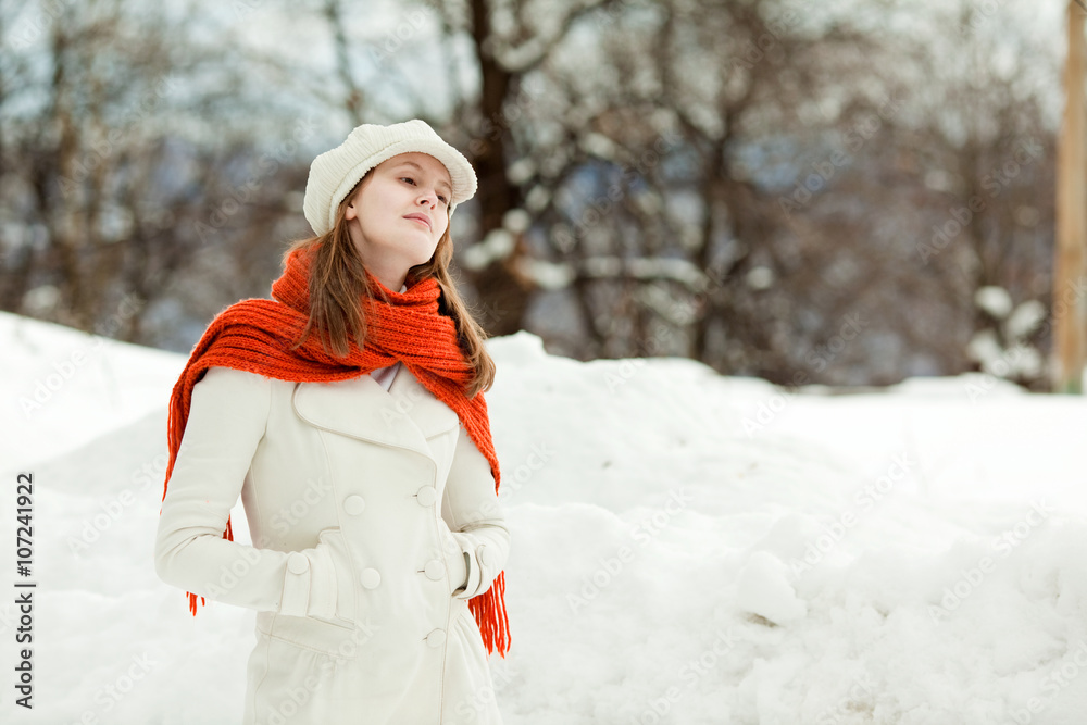 Obraz premium beautiful relaxed woman with red scarf in a snowy landscape