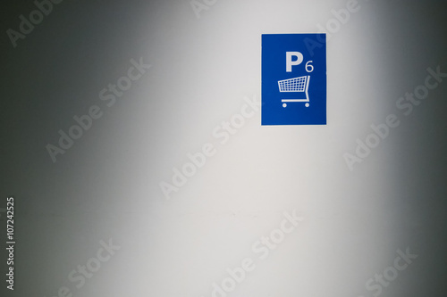 Sign designating parking place #6 for shopping carts photo