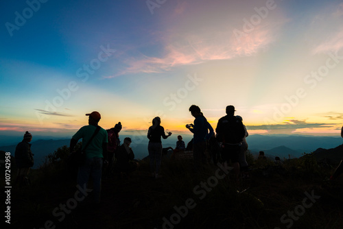 Hiker tourist travelling on the top of mountain for see sunset © themorningglory