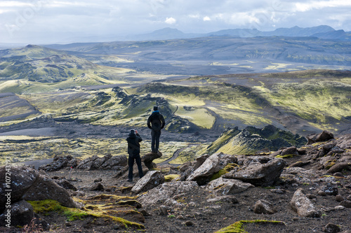 Two hikers looking at volcanic landscape in Lakagigar, Laki craters, Iceland