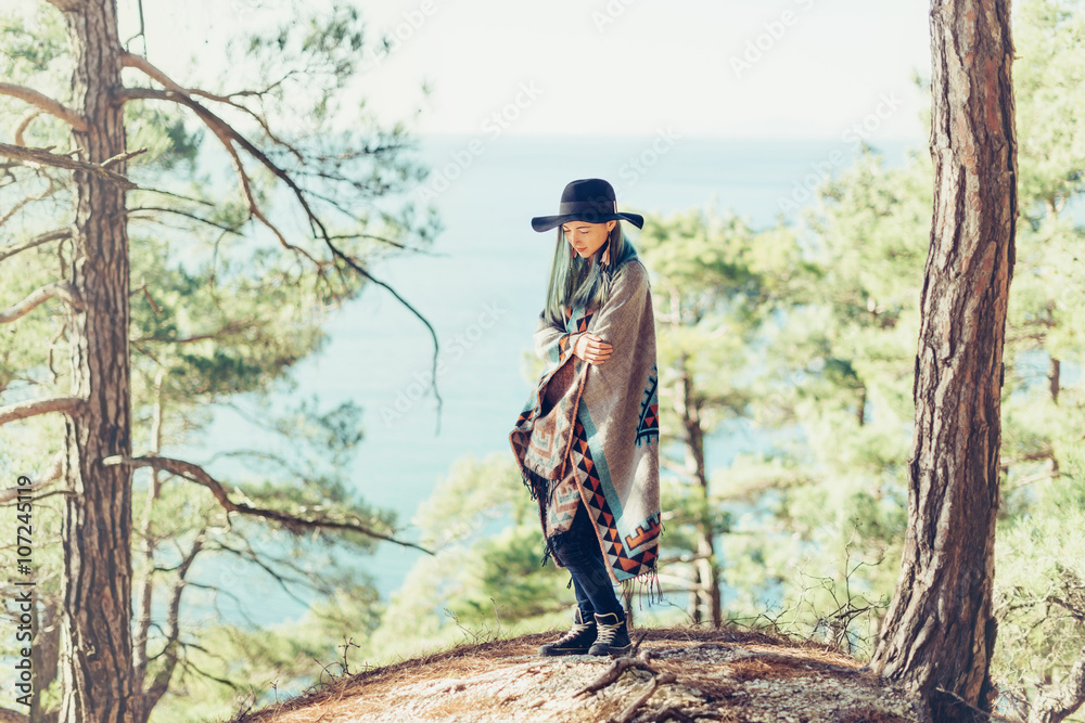 Fototapeta premium Fashionable girl walking on coast