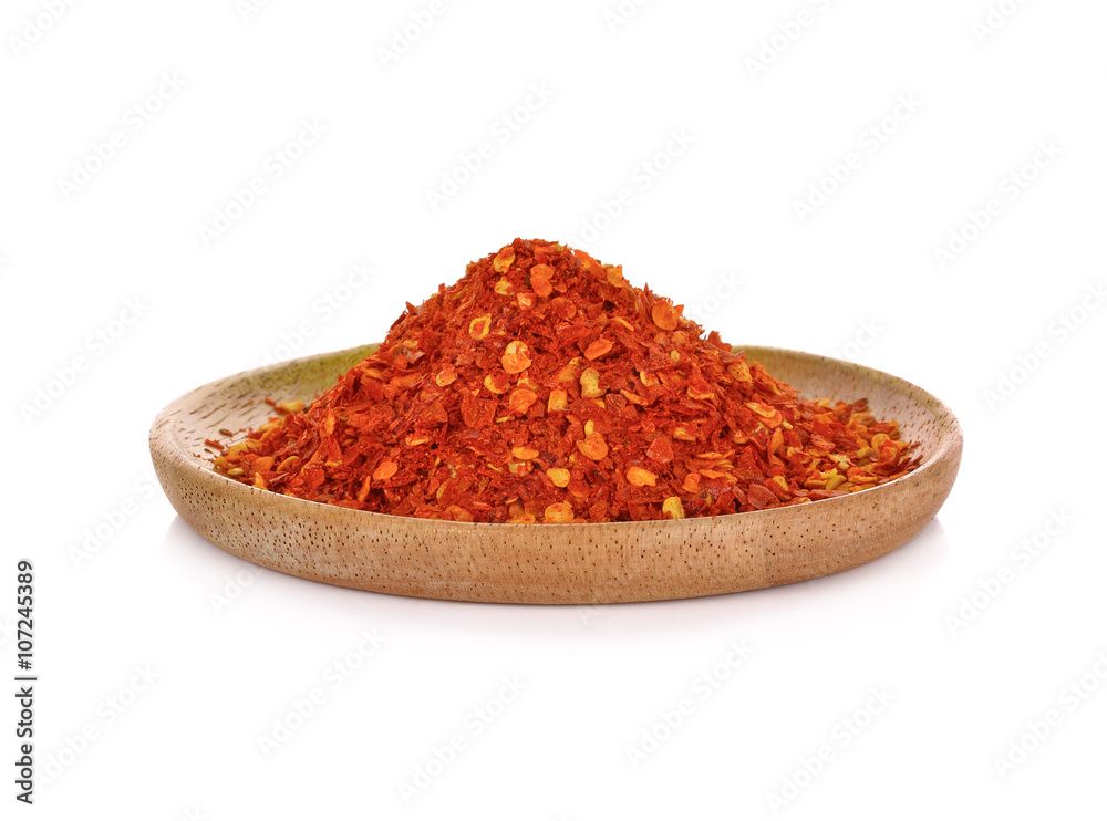 Red Chili Pepper powder in wooden plate on white background Red Chili Pepper powder in wooden plate on white background