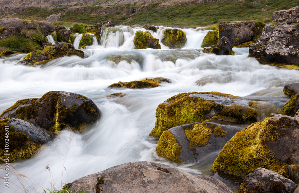 Landscape with small waterfall, part of Dynjandi waterfall, long exposure, Iceland Landscape with small waterfall, part of Dynjandi waterfall, long exposure, Iceland