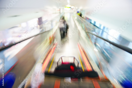 Blur image of people walking down the escalator at airport. © nelzajamal