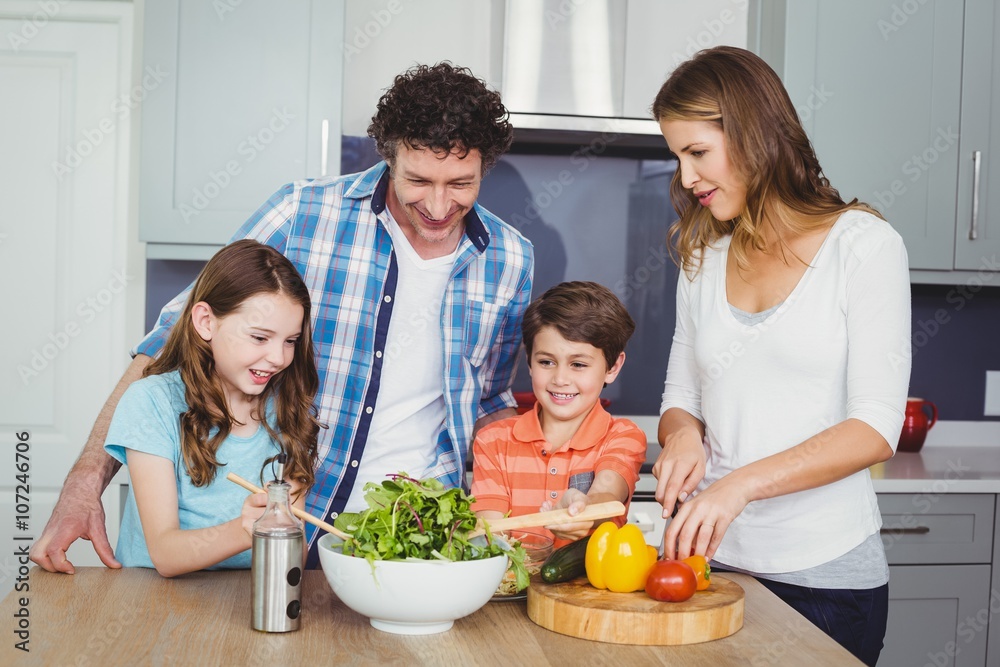 Family preparing vegetable salad Family preparing vegetable salad