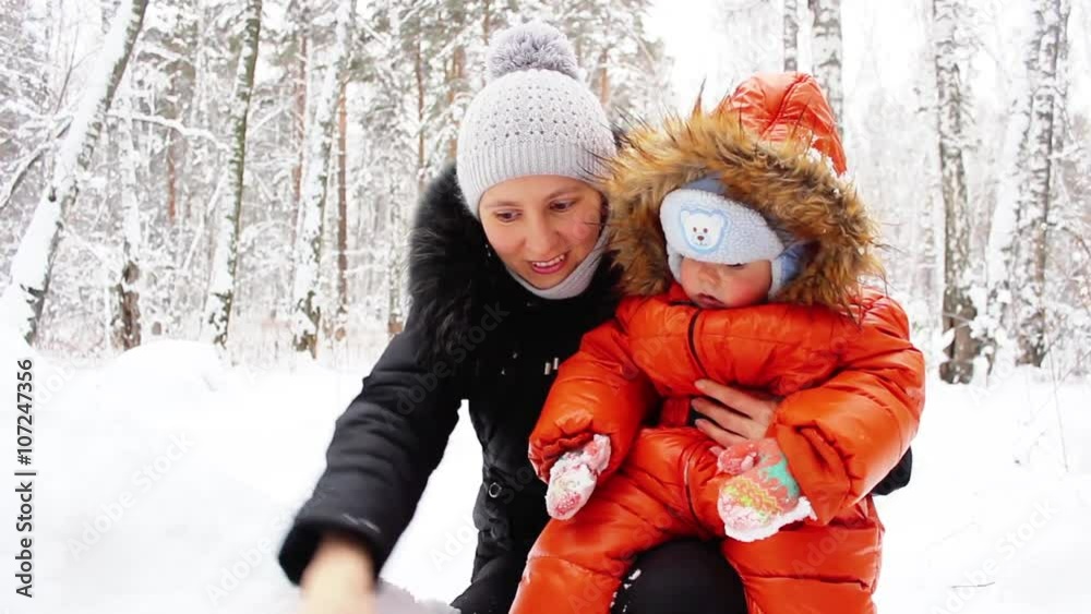 Mother with child in winter forest Mother with child in winter forest
