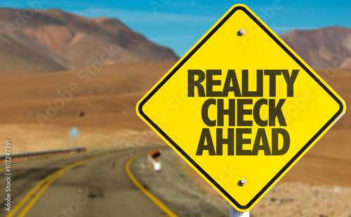 Reality Check Ahead sign on desert road photo