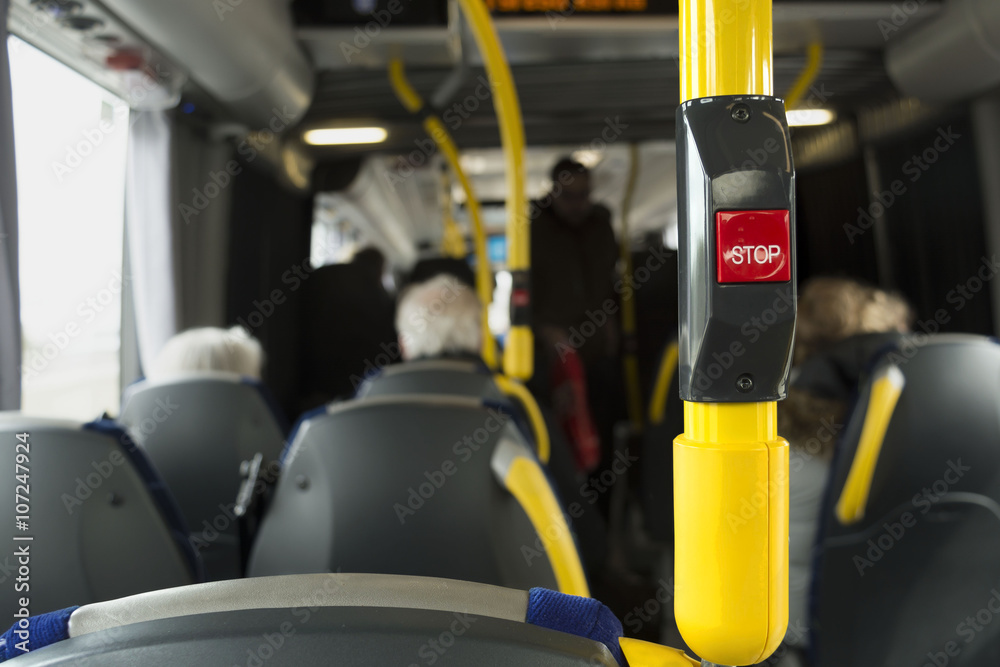 Yellow handrail on the bus with stop button Yellow handrail on the bus with stop button