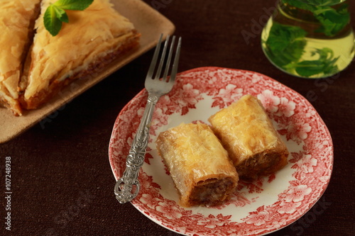 Baklava, turkish traditional delight with fresh mint and figs.