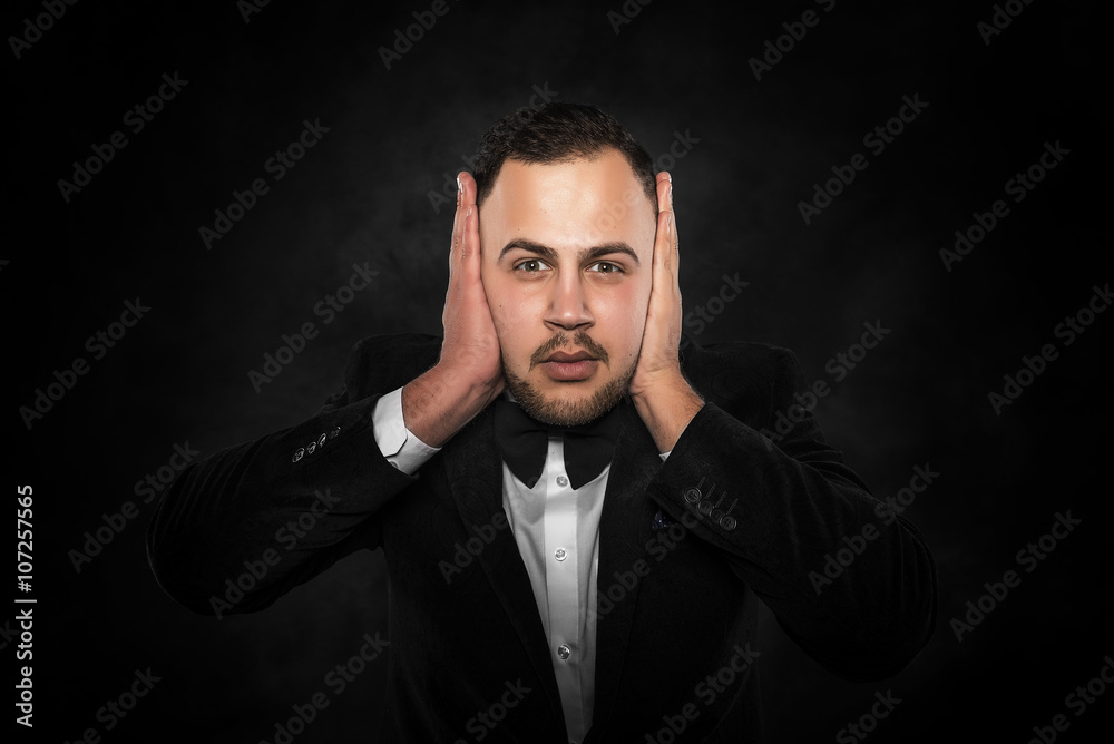 Man covering his ears.