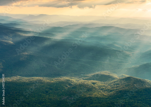 Vibrant horizontal landscape, foggy mountains.