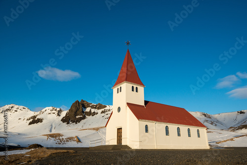 Old red wooden church at sunset, Vik town, Iceland