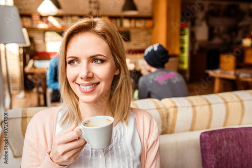 Woman in cafe drinking coffee  enjoying her espresso