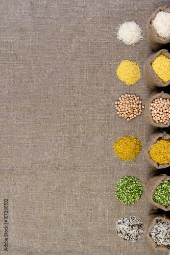 Set groats  peas  rice  millet  peas in sacks  burlap on wooden background