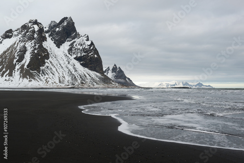 Stokksnes Peninsula, Vestrahorn mountains and black sand ocean coast line, Iceland photo