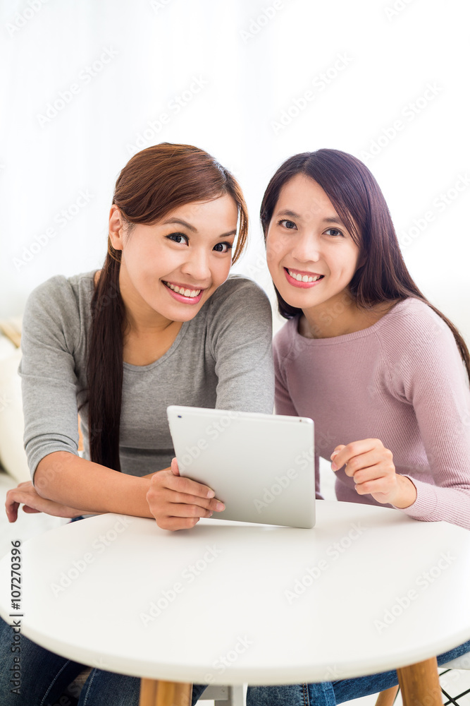 Two young woman use of digital tablet pc Two young woman use of digital tablet pc
