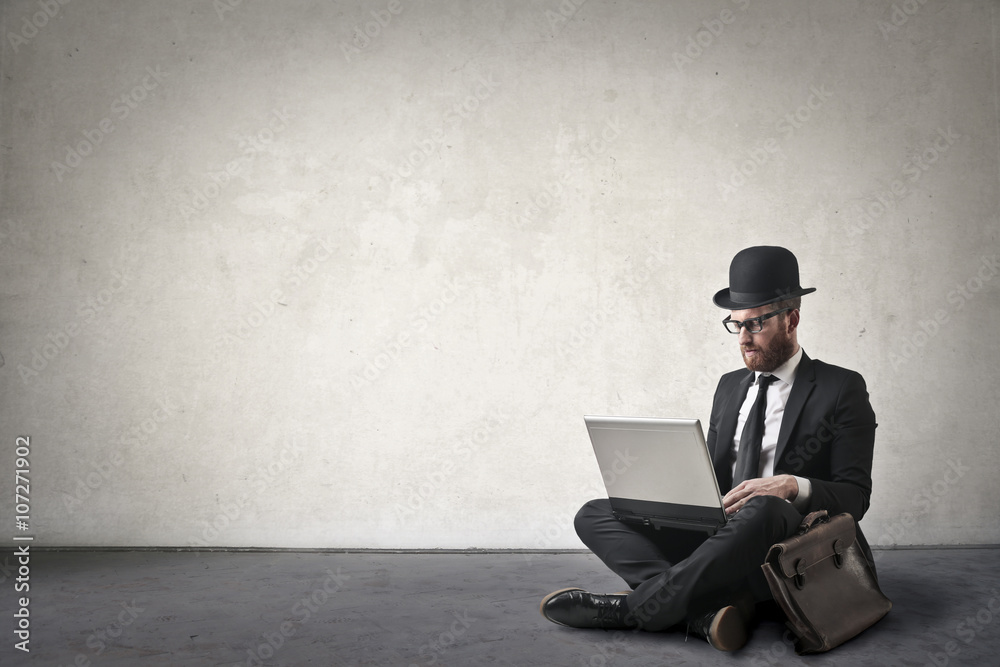 Fototapeta premium Businessman sitting on the ground