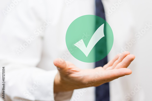 businessman showing virtual approved check mark photo