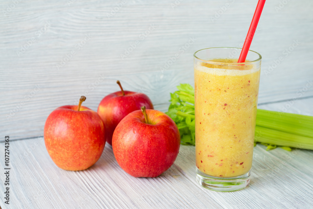 Smoothies made from apples and celery in a glass with a straw on Smoothies made from apples and celery in a glass with a straw on