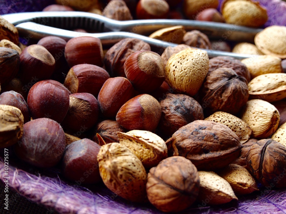 Mix of nuts, almonds and walnuts with nutcracker Mix of nuts, almonds and walnuts with nutcracker