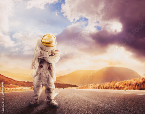 Astronaut standing on a road