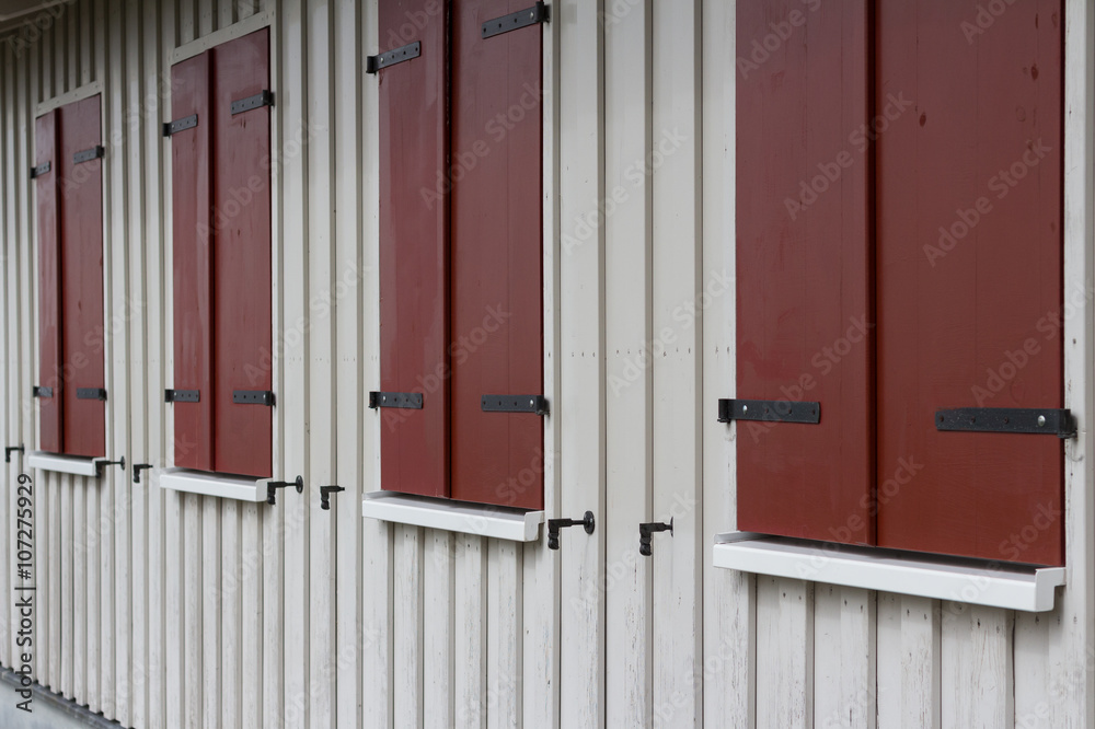 wooden house exterior with closed window shutters wooden house exterior with closed window shutters