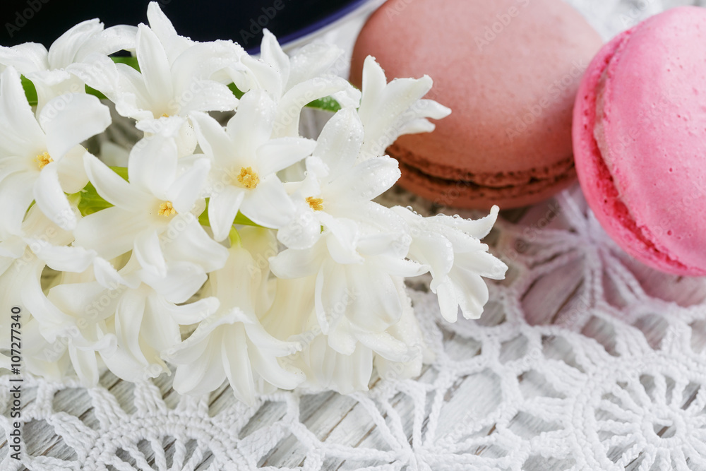 Cup of green tea, color macaroon and white flowers Cup of green tea, color macaroon and white flowers