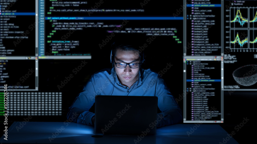 Young programmer in headphones working on new project Young programmer in headphones working on new project