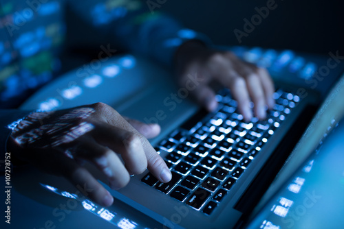 Fototapeta Close-up image of coder typing on computer