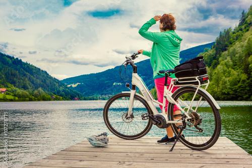 woman with e-bike resting beside a beautiful lake-e-power 21