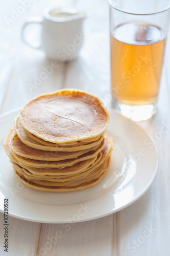 Light breakfast. Fresh pancakes on white plate  in morning light