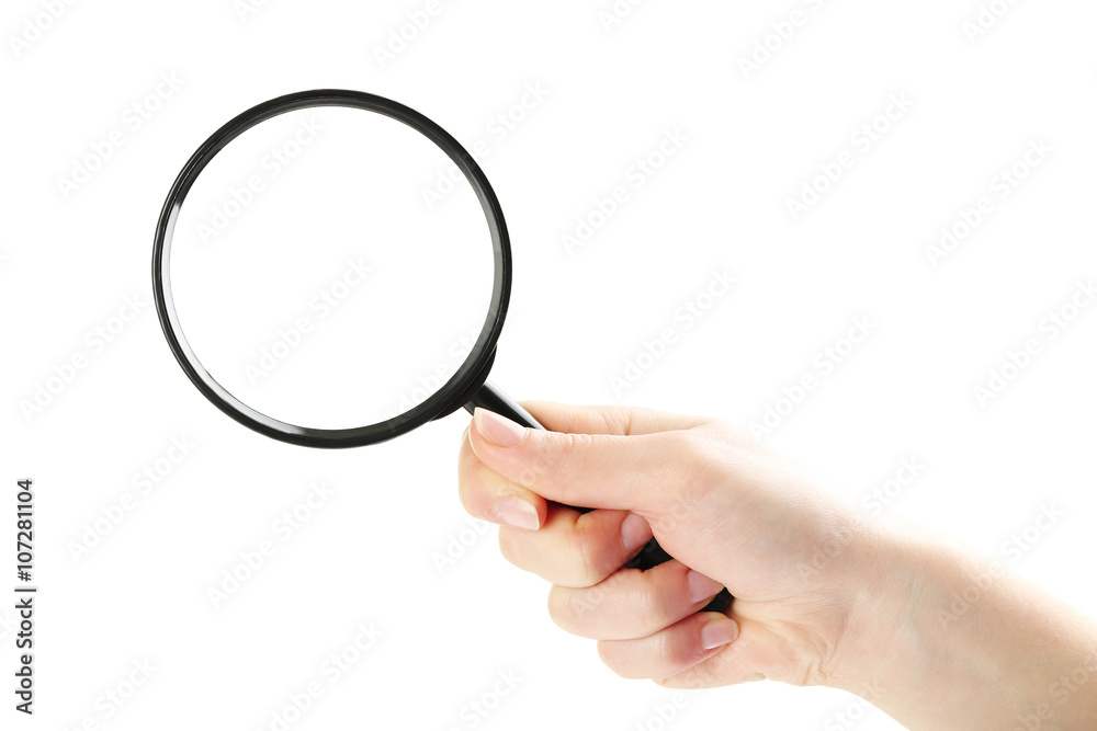 Female hand holding magnifying glass on a white background Female hand holding magnifying glass on a white background
