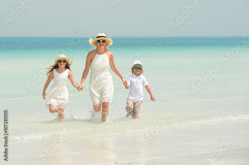 Mother with children have fun on the beach