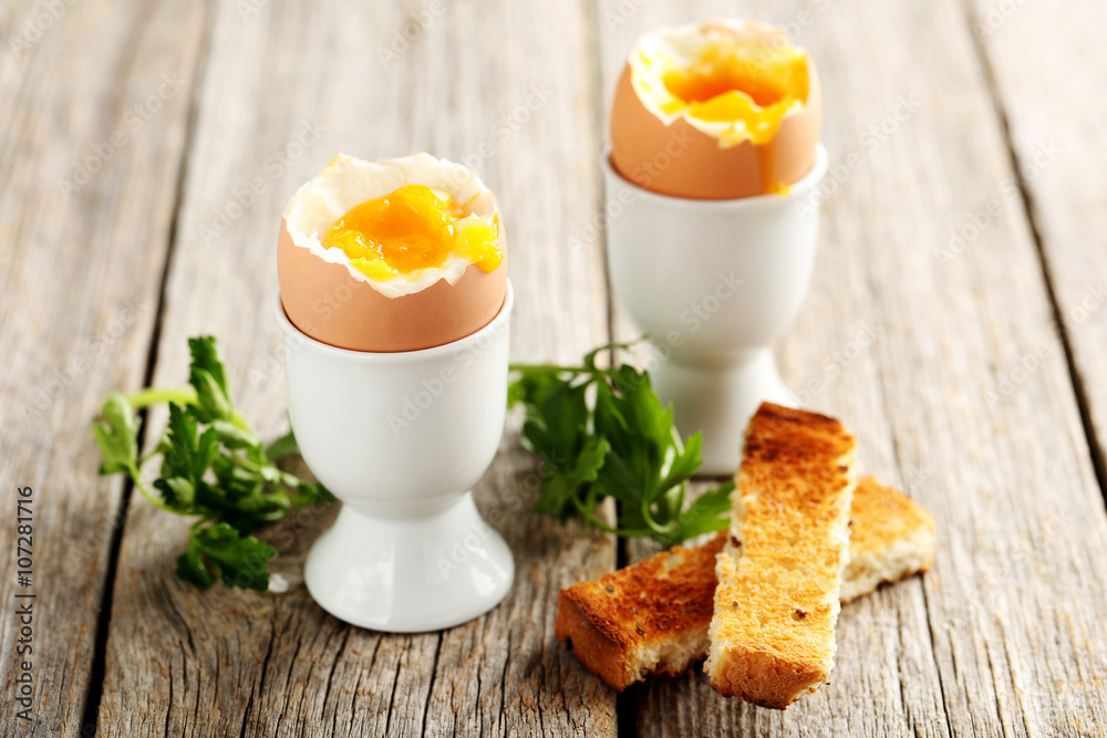 Boiled egg with toasts on a grey wooden table Boiled egg with toasts on a grey wooden table