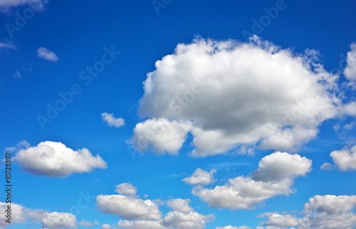 Blue sky background with fluffy clouds