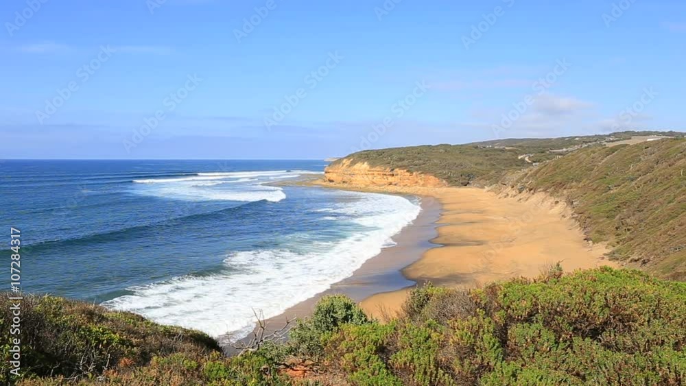 High steep beautiful beach and a long deserted beach with yellow sand with large stones and beautiful blue turquoise ocean along the Great Ocean Road, Australia High steep beautiful beach and a long deserted beach with yellow sand with large stones and beautiful blue turquoise ocean along the Great Ocean Road, Australia