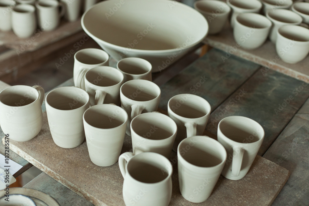 tabletop of unfinished ceramic or clay works in a pottery tabletop of unfinished ceramic or clay works in a pottery