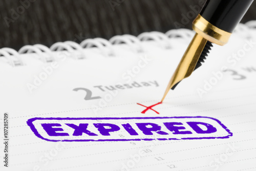 Stamp expired and fountain pen close-up.