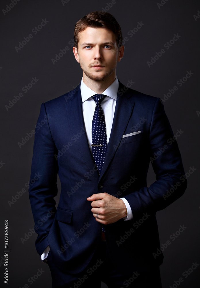 Cool businessman standing on grey Cool businessman standing on grey