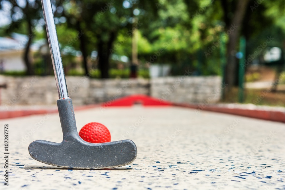 Closeup of red mini golf ball.